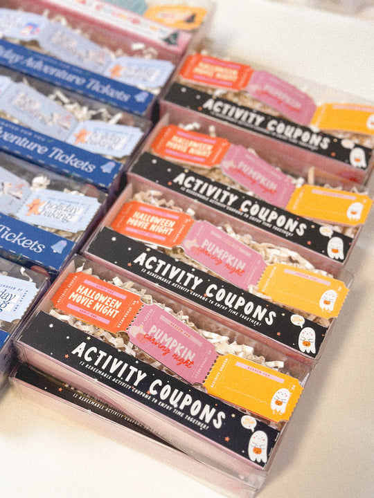 Packaged activity coupons with various themes on a white surface
