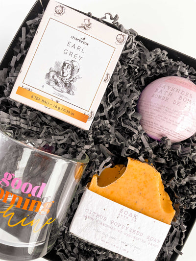 Bright and colorful spa gift box. Good morning sunshine mug, earl grey tea, bath bombs, and poppy seed soap. Bright, vibrant colors perfect for a modern gift for mothers day, a birthday, christmas, thank you gift, or any occasion . 