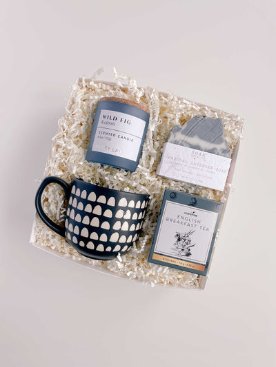 Curated gift box for mothers day or birthdays. White gift box with crinkle paper, filled with wild and fig candle, charcoal lavender soap bar from canadian small business, large ceramic mug, and english tea. Local delivery Halifax, shipping mothers day gift boxes Canada wide. 